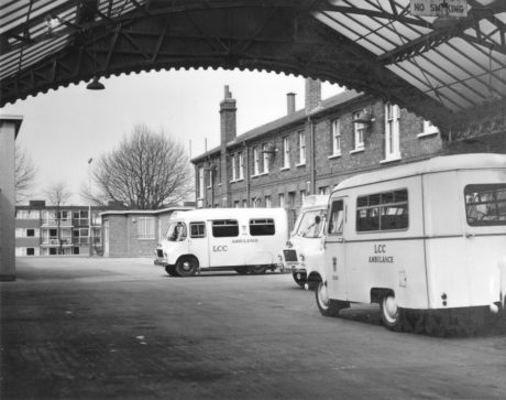 Nineteen sixties ambulances parked
