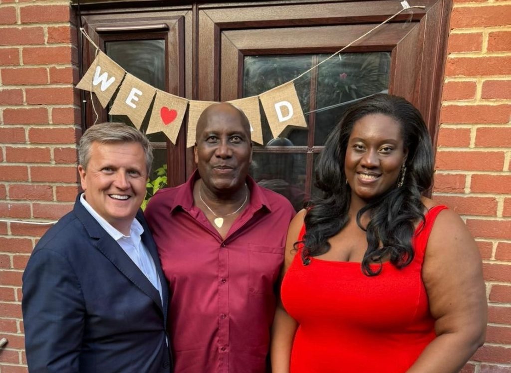 Aled Jones standing next to Eddie and Estelle at their home in London. 
