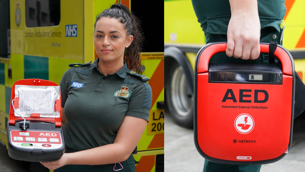 A London Paramedic holding up a public-access defibrillator. 