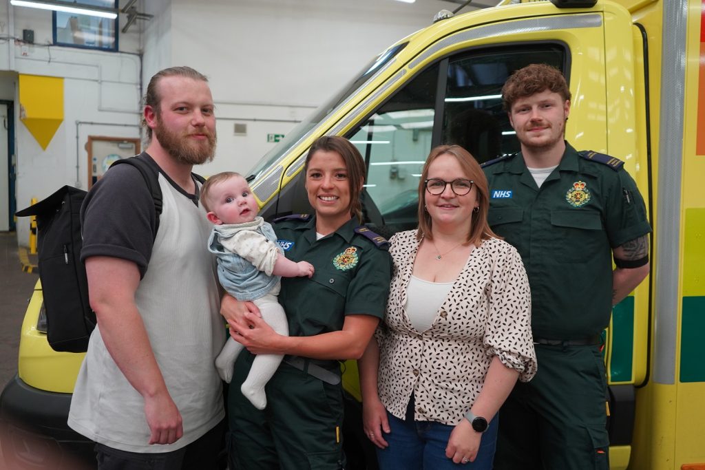 A group photo of Dad Michael, Courtney holding baby Lydia, mum Abie, Corey