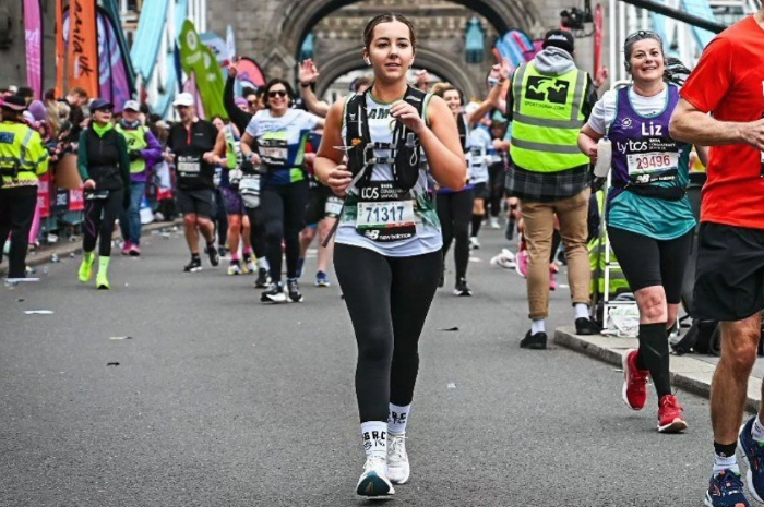 An LAS Charity runner crossing Tower Bridge at the London Marathon.