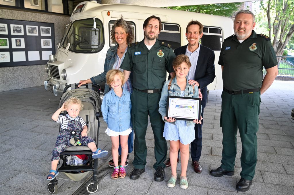 Farah and her family with some London Ambulance Service staff members