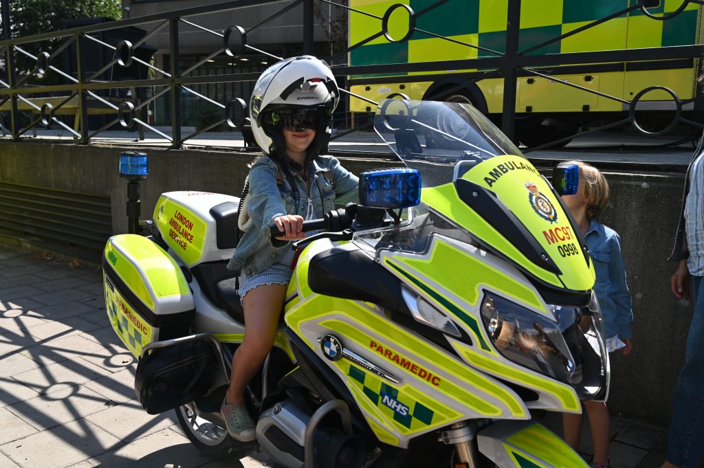 Farah sitting on an LAS motorcycle during the visit