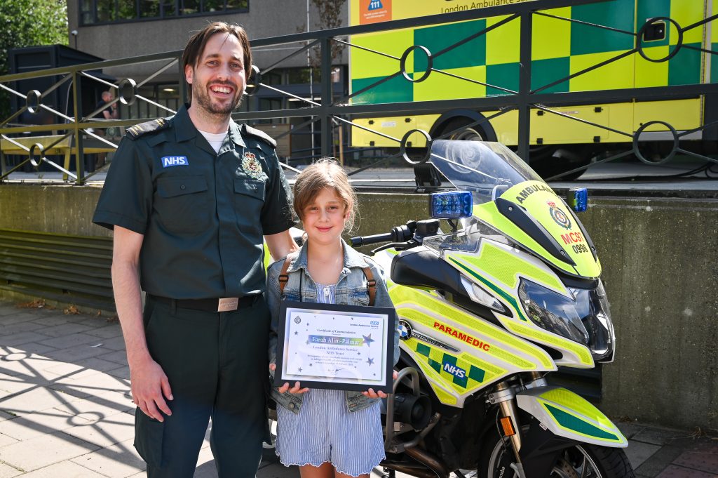 Call hander Matthew with brave Farah who took over the 999 call while her mum helped her baby brother after he got burned