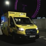 An electric ambulance in front of the London Eye.